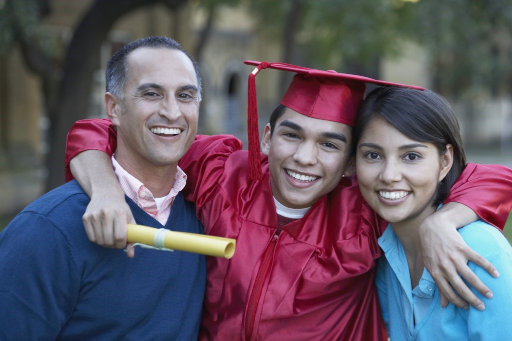 Cheerful student graduated from college with his family.